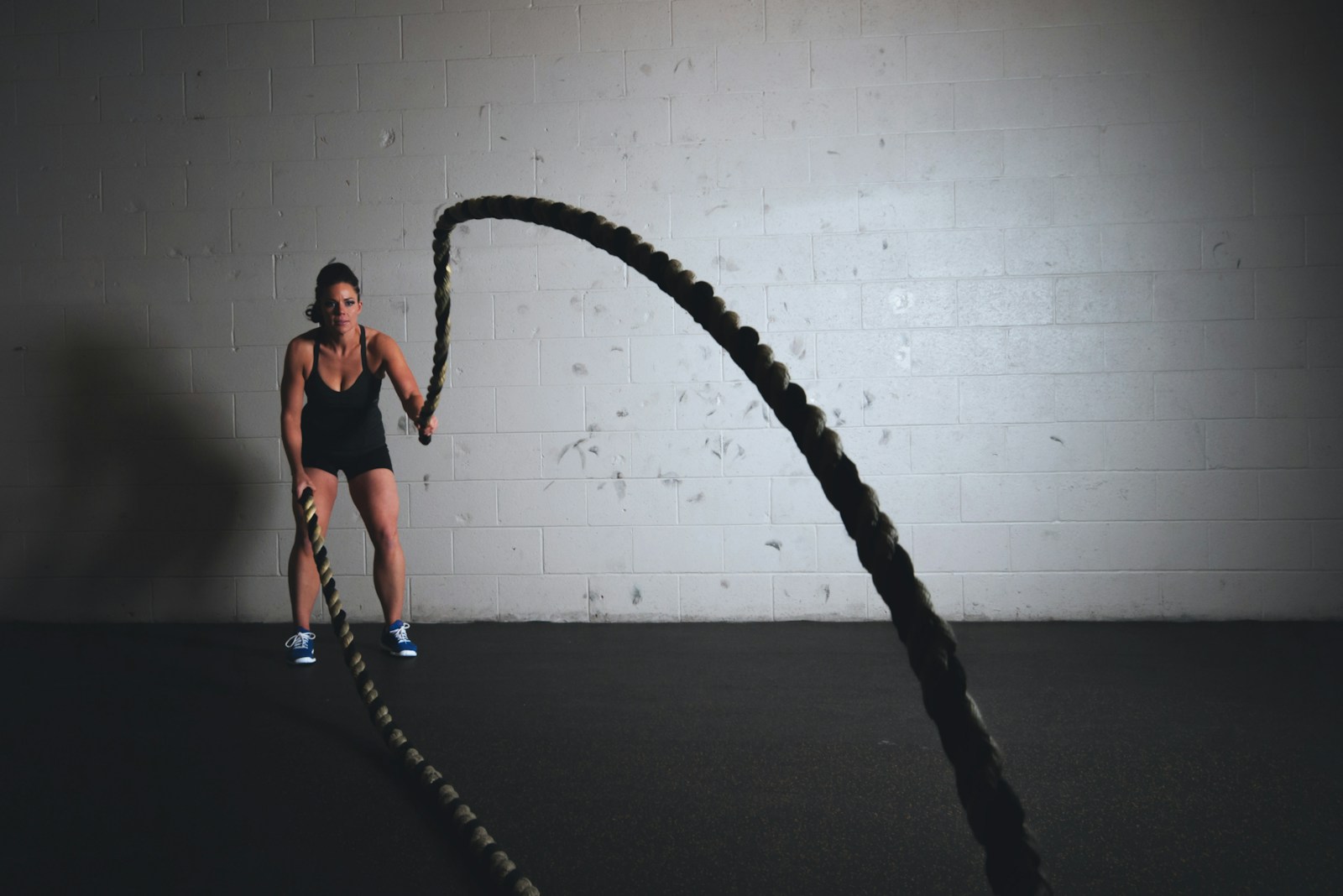 Member working the battle ropes