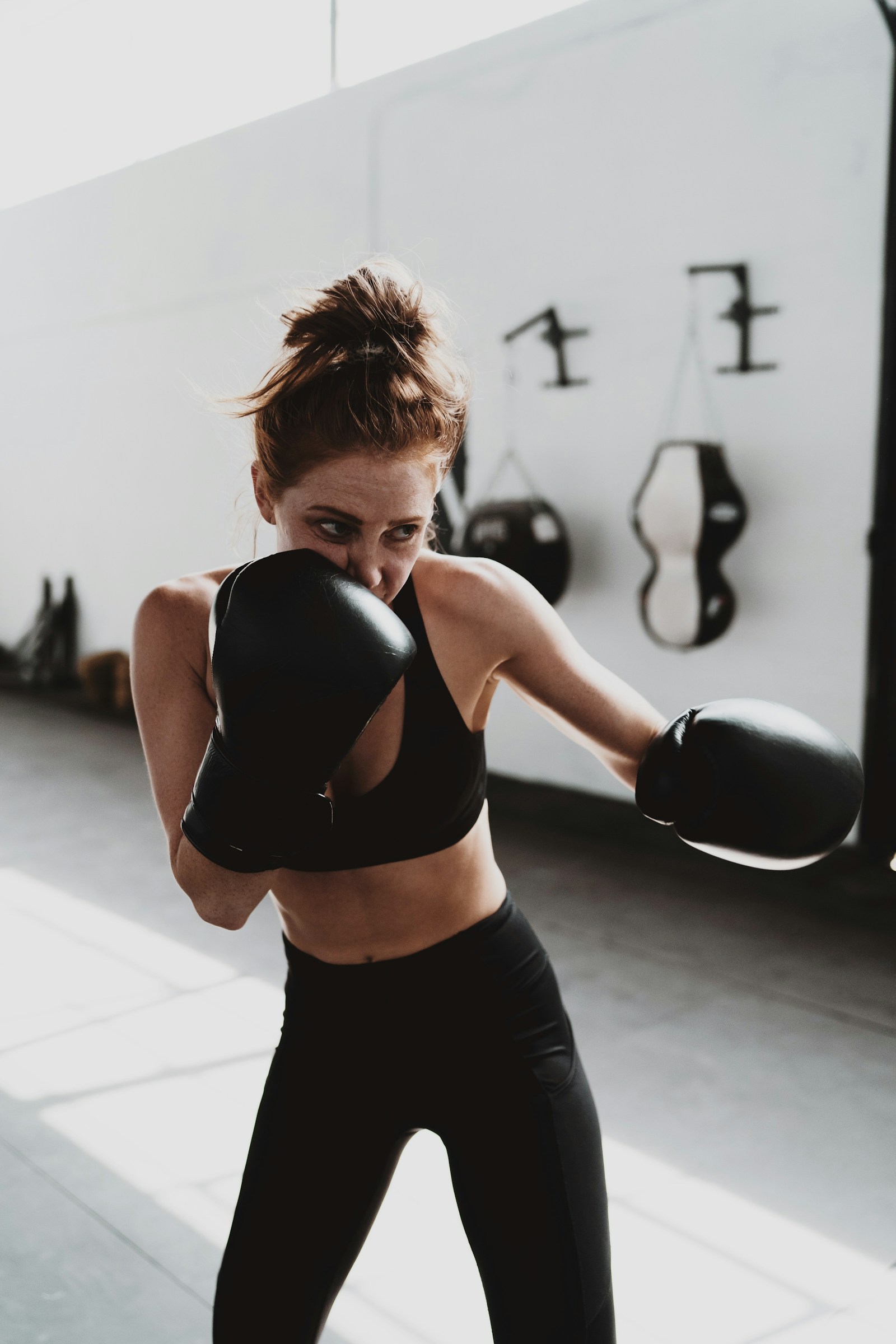 Member throwing a punch in boxing gloves